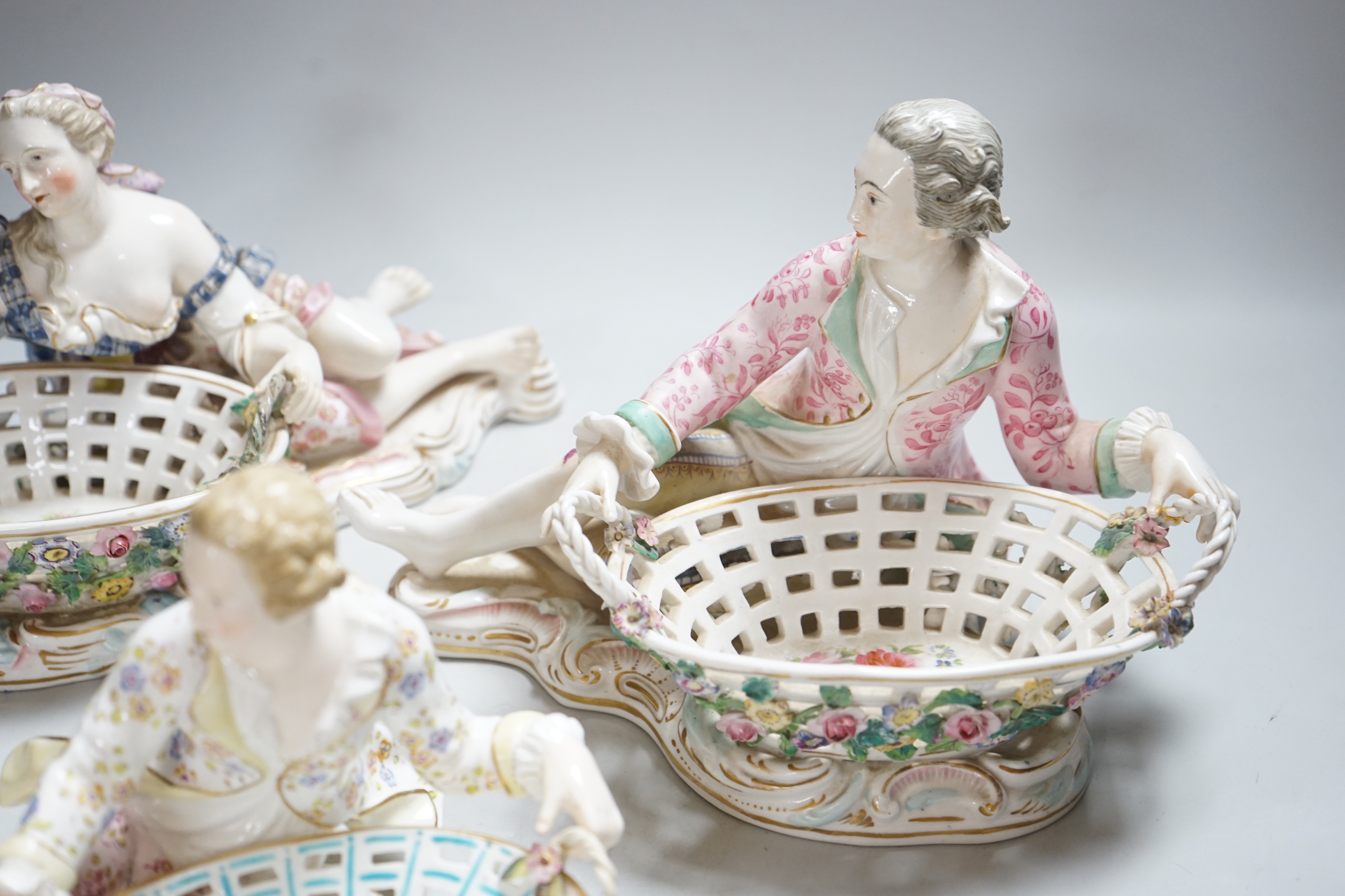 Three English porcelain Meissen style figural baskets, highest 18cm